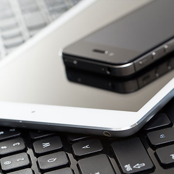 Phone and tablet on a keyboard